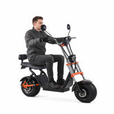 an adult riding a fat tyre kugoo harley electric scooter