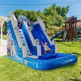 Inflatable slide with cartoon characters on a grassy area