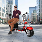 Man sitting on a red electric scooter