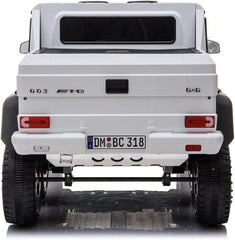Back view of a white off-road vehicle with AMG