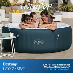 Inflatable hot tub with four people around it, featuring the Lay-Z-Spa brand