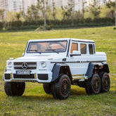 White toy Mercedes-Benz G-Class on grass