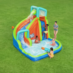 Children playing around a colorful inflatable water slide and pool