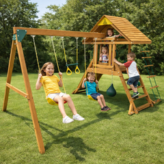Children playing on a wooden swing set with a playhouse and multiple activities in a park.