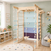 A large Customised Indoor Wooden Gymnastics Playset for Kids with a climbing ladder in a styled nursery - 127 x 115 x 204 cms .