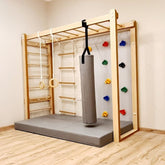 Children's play with a climbing wall, monkey bars, and a punching bag
