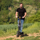 A Person ride on Jeep 2XE Urban Camou foldable electric scooter