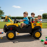 Three children playing with Caterpillar Dump Truck