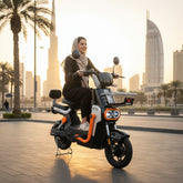 Woman riding an electric scooter with a cityscape