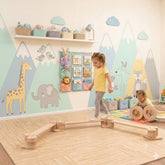 A child's playroom with a young girl walking over a Wooden Balance Beam for Kids Indoor Playset.
