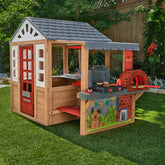 Wooden playhouse with kitchen and pizza oven grill in garden