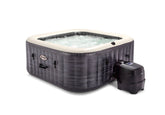 Inflatable hot tub with water and pump