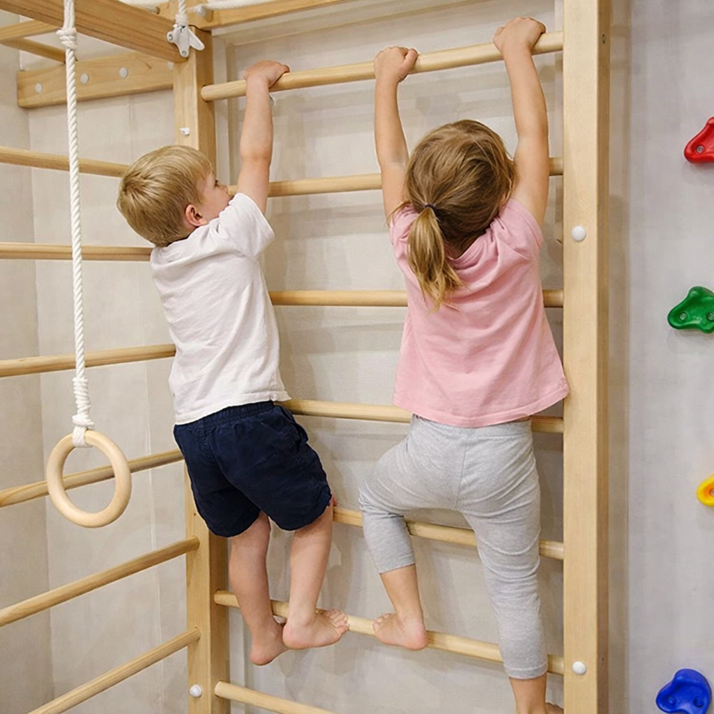 Two children are climbing on a wooden Playset