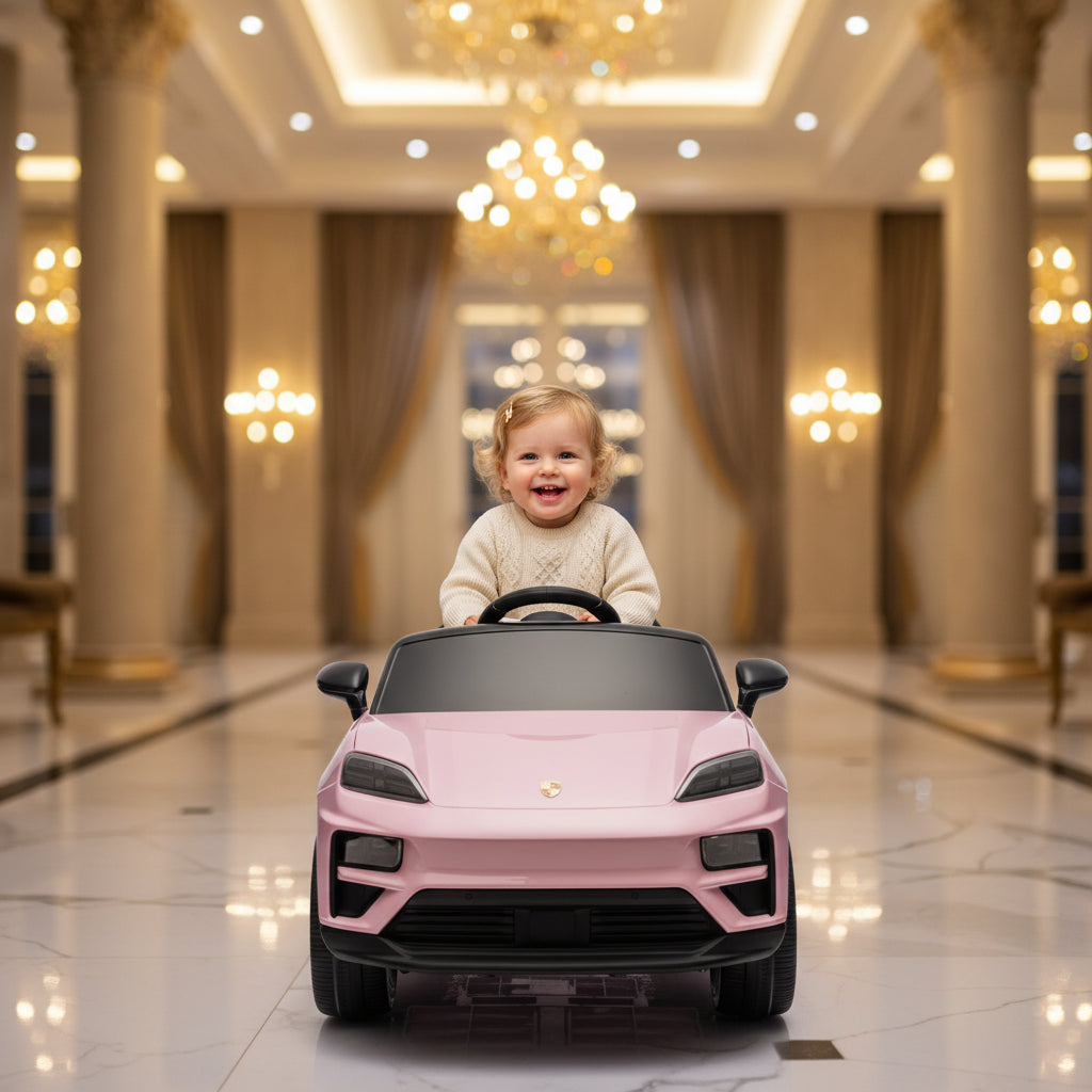 Child in a pink toy car in an elegant indoor