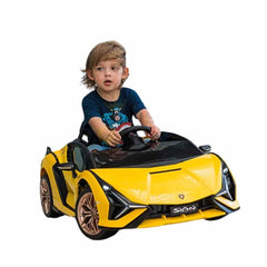 Child sitting in a yellow toy car 