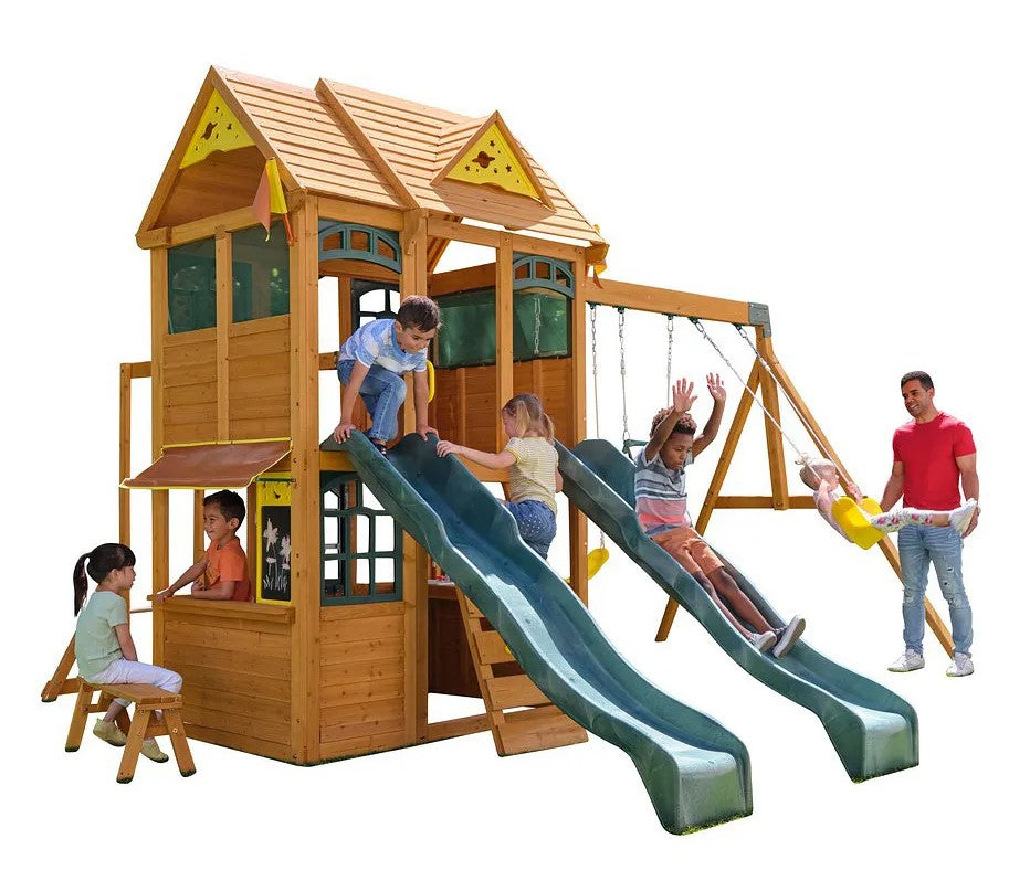 Kidkraft Overland Heights  Children playing on a wooden playset with slides and swings -472 x 417 x 289.6cm
