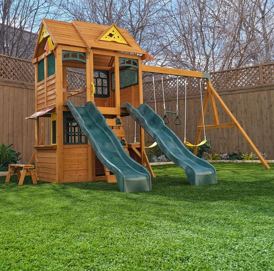 Kidkraft Overland Heights Wooden playset with slides and swings on a grassy backyard