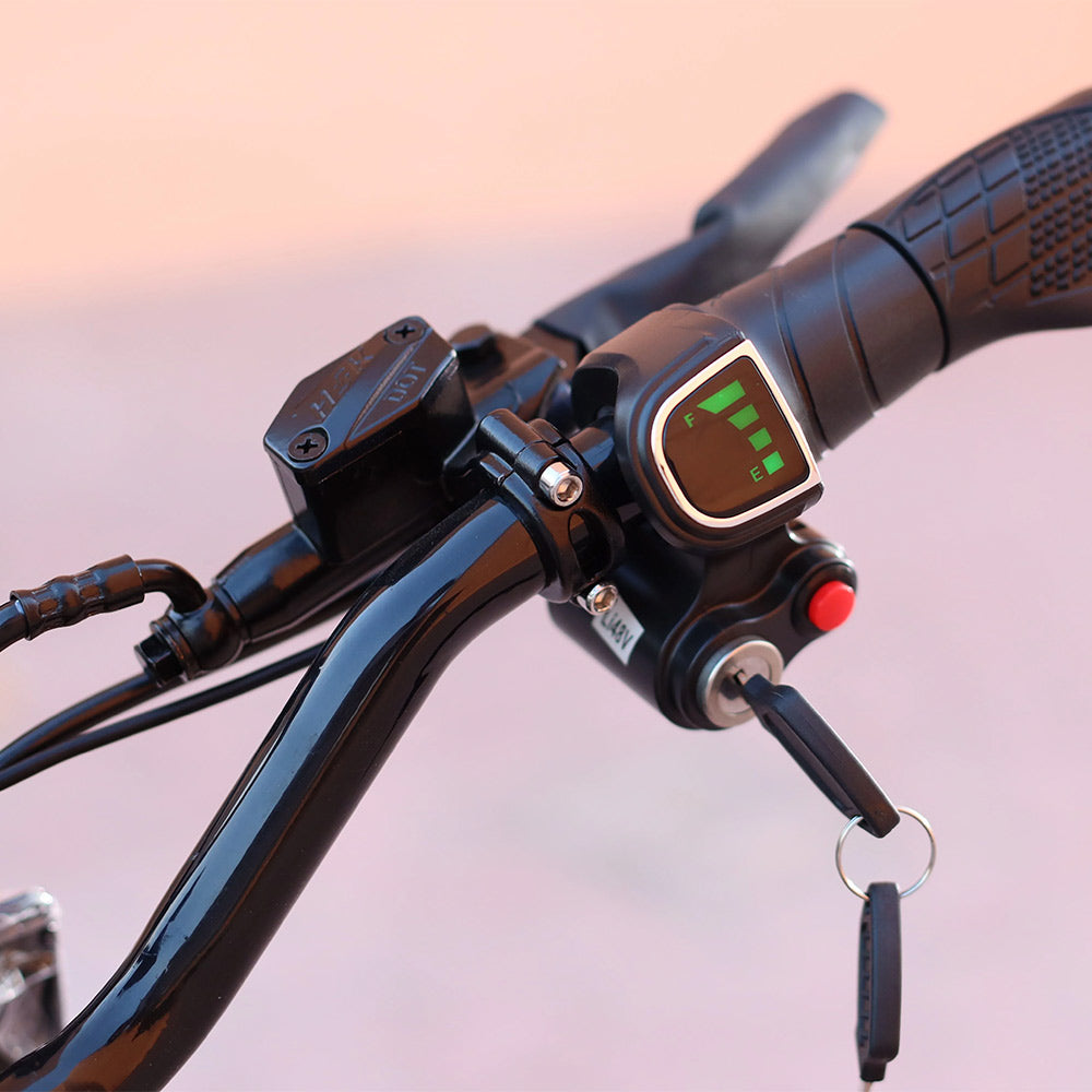 Close-up of a motorcycle handlebar with control panel and digital display