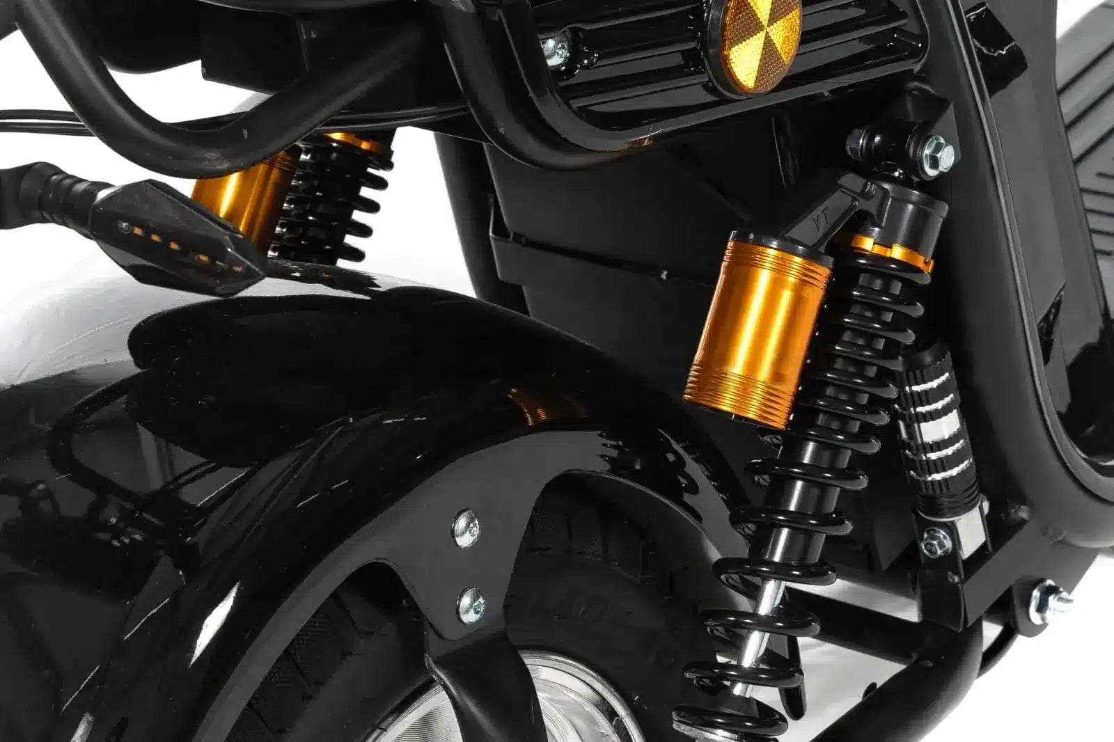 Close-up kugoo electric motorcycle's front suspension system with gold accents on a white background