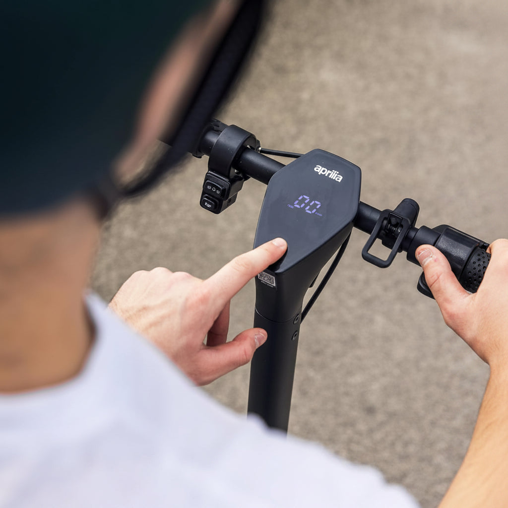 Person using a scooter handle with a digital display