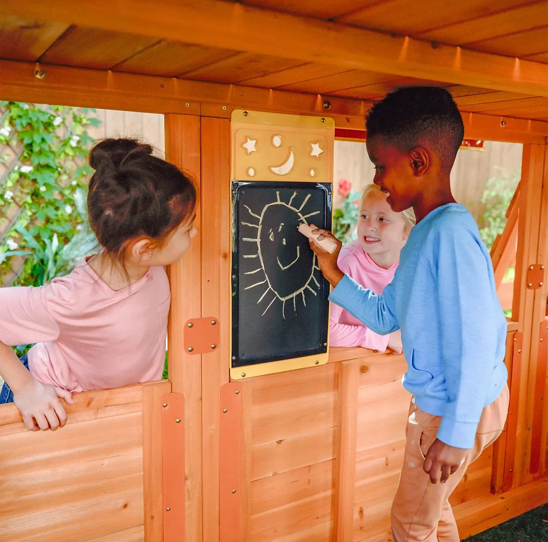 Children interacting with a KidKraft Falcon Ridge Wooden with a chalkboard door.