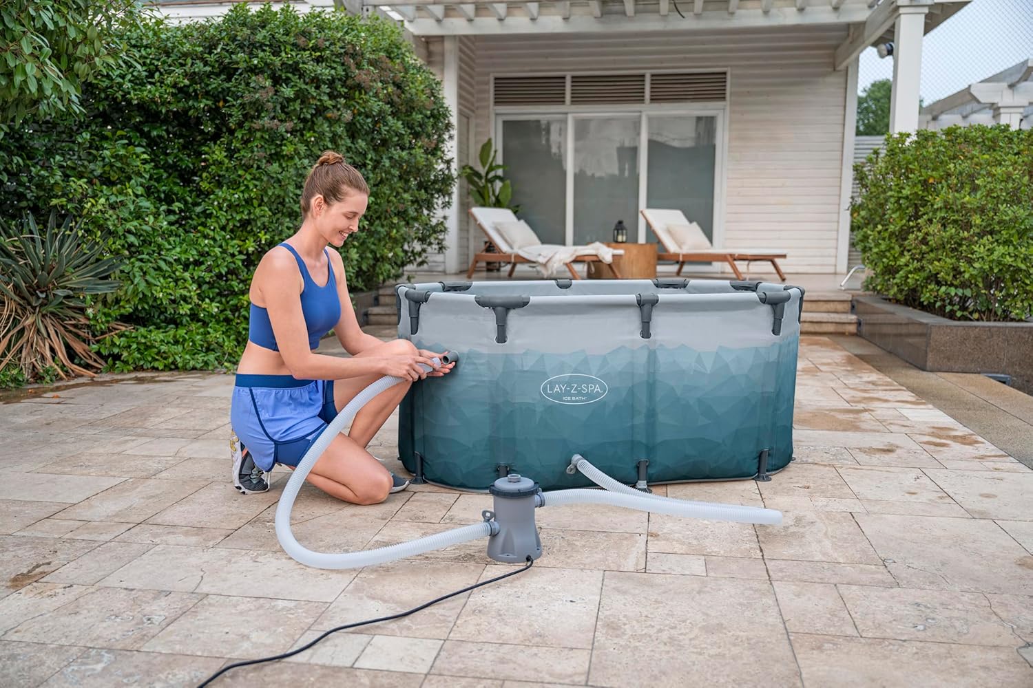 A woman inflating an inflatable Ice tub 