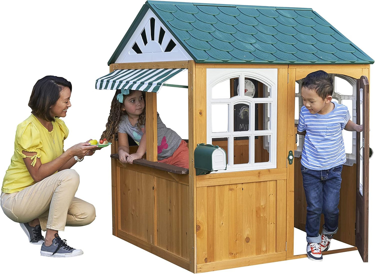 Children playing around a wooden playhouse with mother and kids