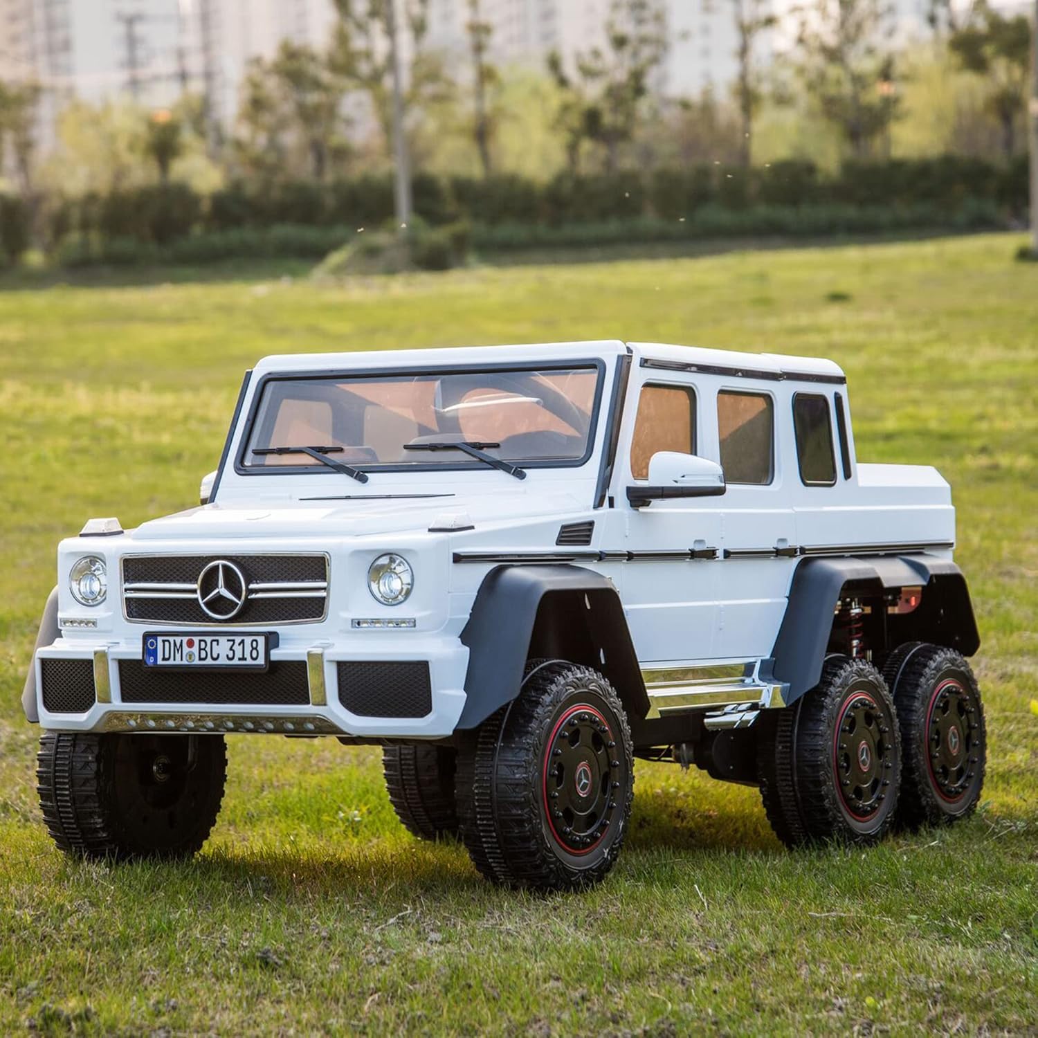 White toy Mercedes-Benz G-Class on grass 