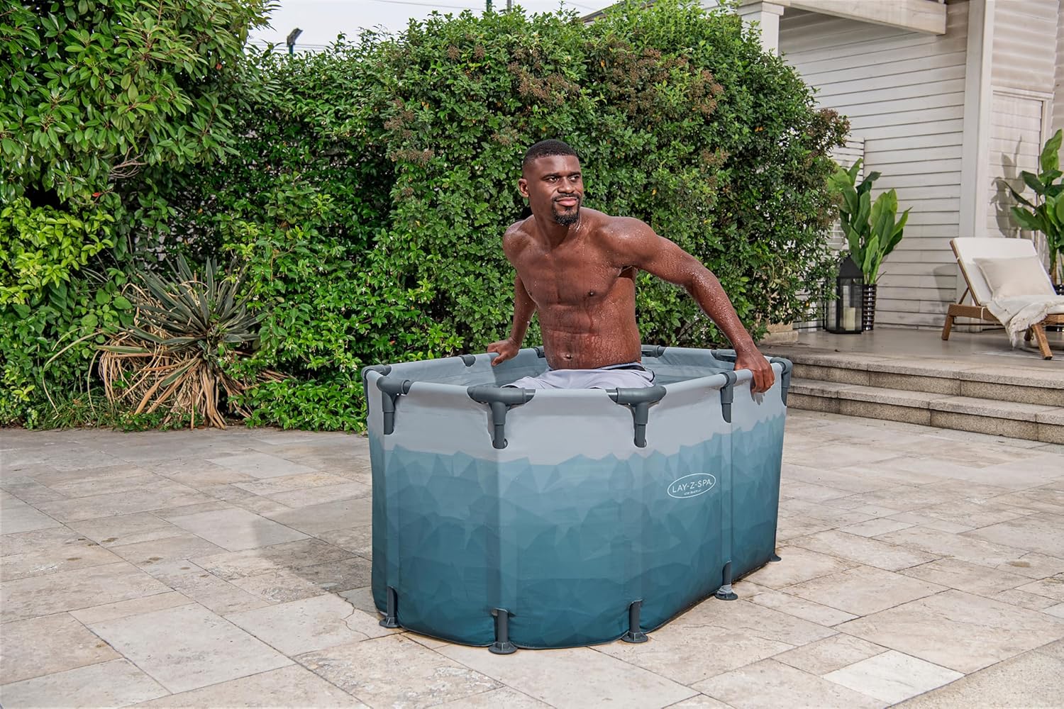 A man sitting in a portable Ice tub