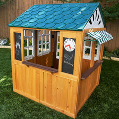 Wooden playhouse with a blue roof and green grass Play Area