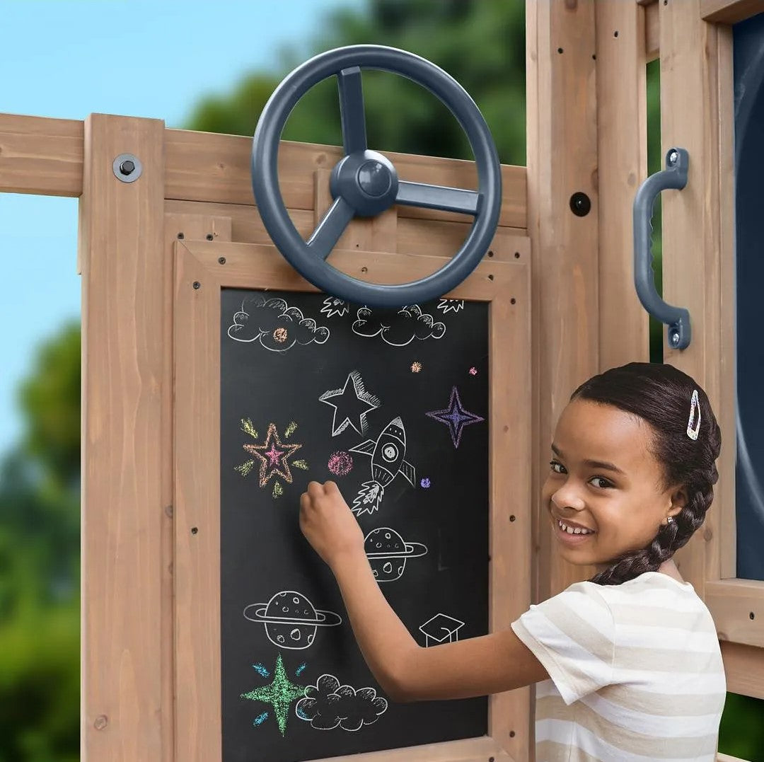 Child drawing on a chalkboard at Gorilla Playsets.