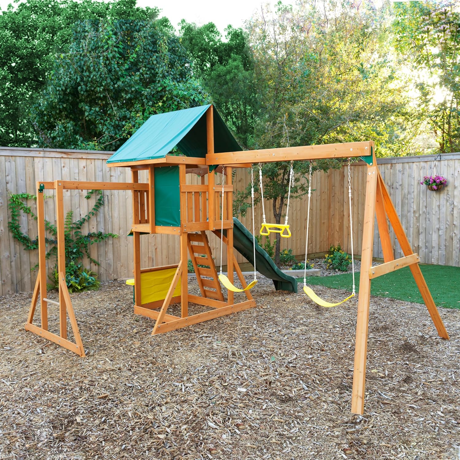 Kidkraft Brightside Wooden playground set with swings and slide in a backyard