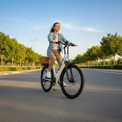 Woman riding a electric bike on a sunny day with trees in the background
