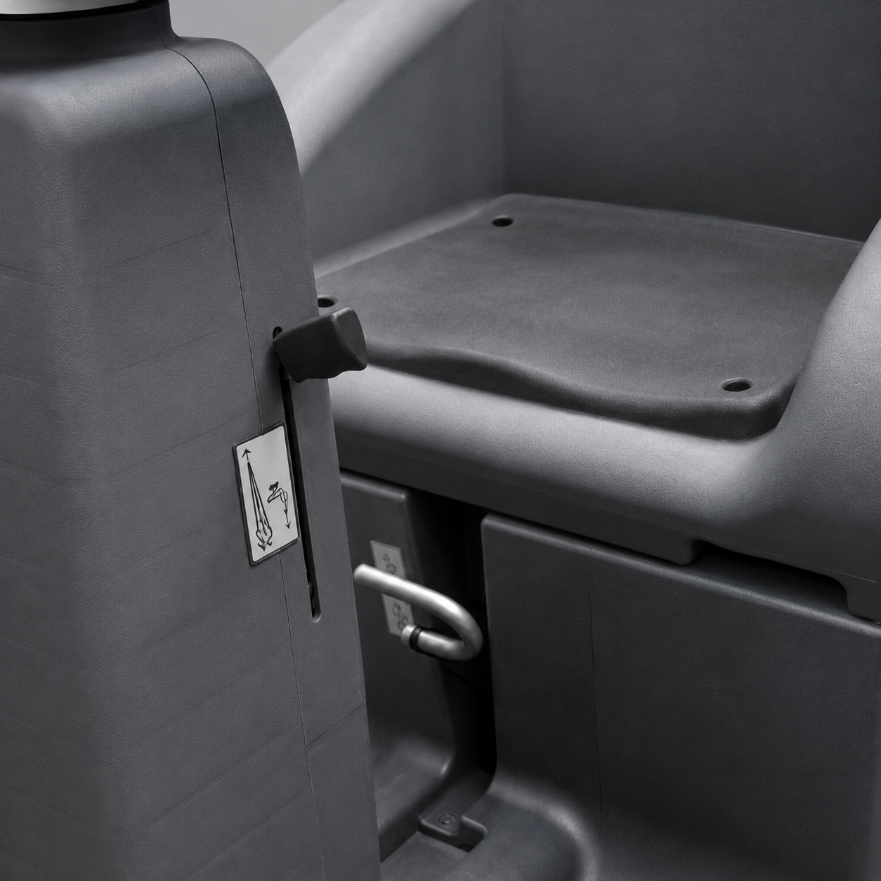 Close-up of a dark grey plastic seat