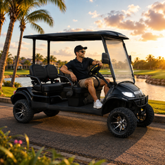 Man driving a black keon Off road golf cart on a golf course at sunset