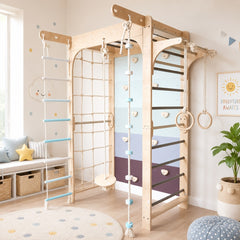 A large Customised wooden indoor play gym with climbing walls, a rope ladder, and hanging rings