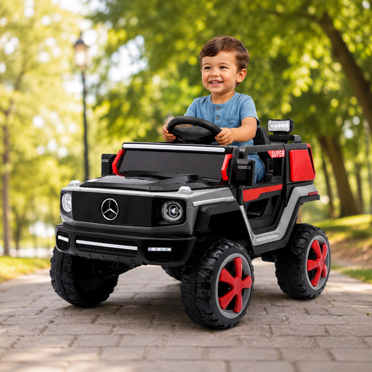 A young boy driving a black and red Mercedes-Benz style ride-on toy car with 2 seats