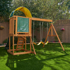 Kidkraft Ainsley Outdoor Playset with a swing and climbing structure on grass