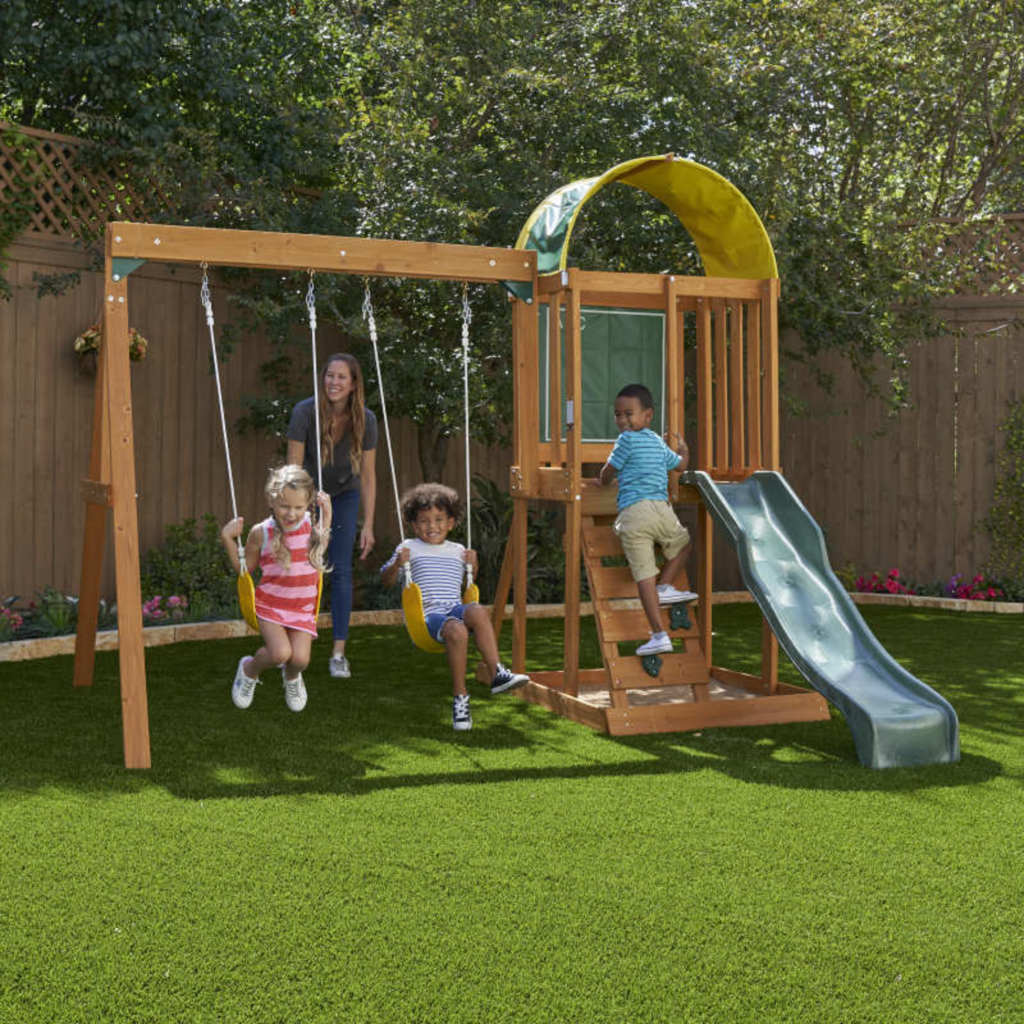 Kidkraft Ainsley Outdoor Playset with a slide in a backyard.