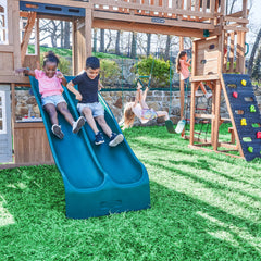 Children playing on a blue slide in a playground with Treetop Observatory Wooden Swing and Slide Playset.