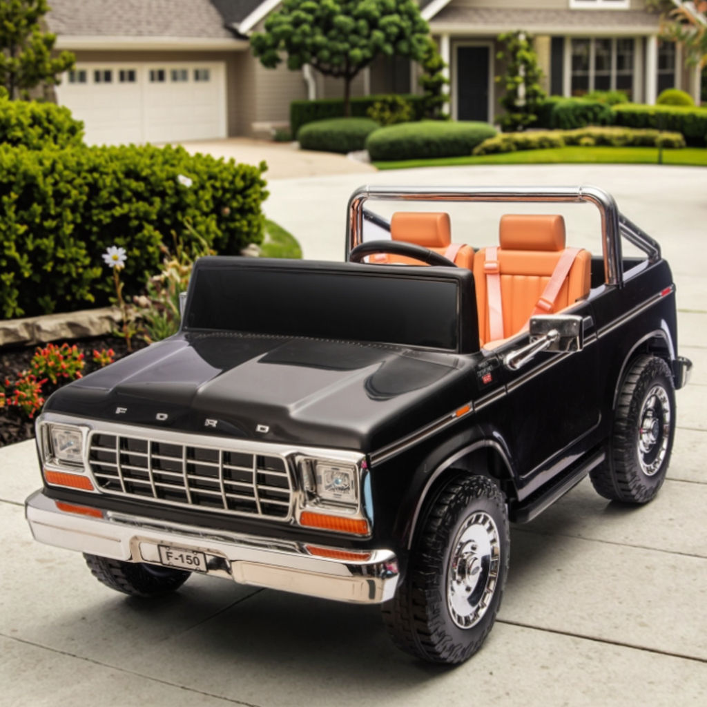 Front view of a black ride-on toy Car with orange Leather seats 