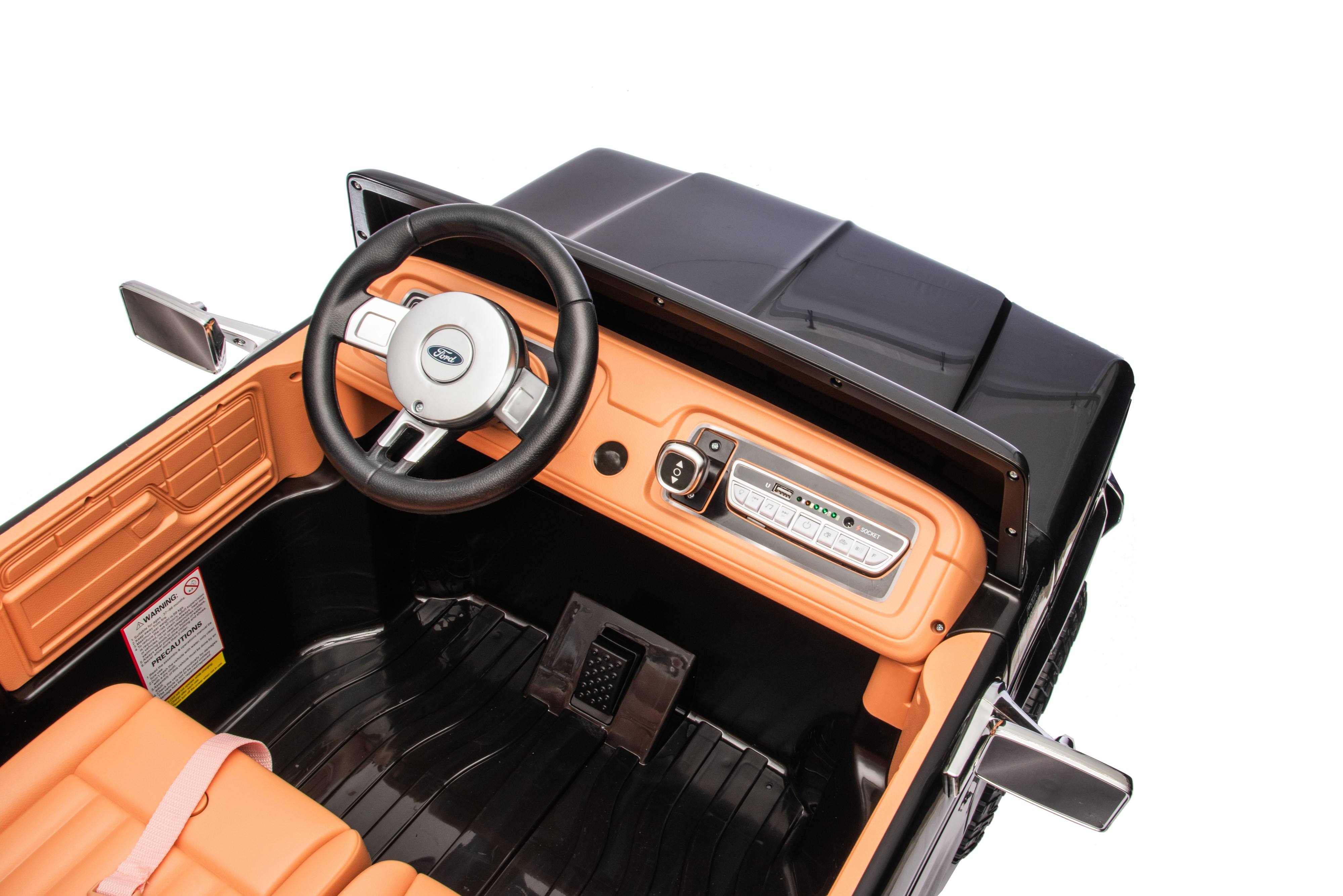 Close-up of a toy car's interior with steering wheel and dashboard 