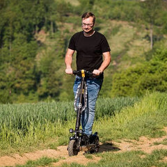 A Person ride on Jeep 2XE Urban Camou foldable electric scooter