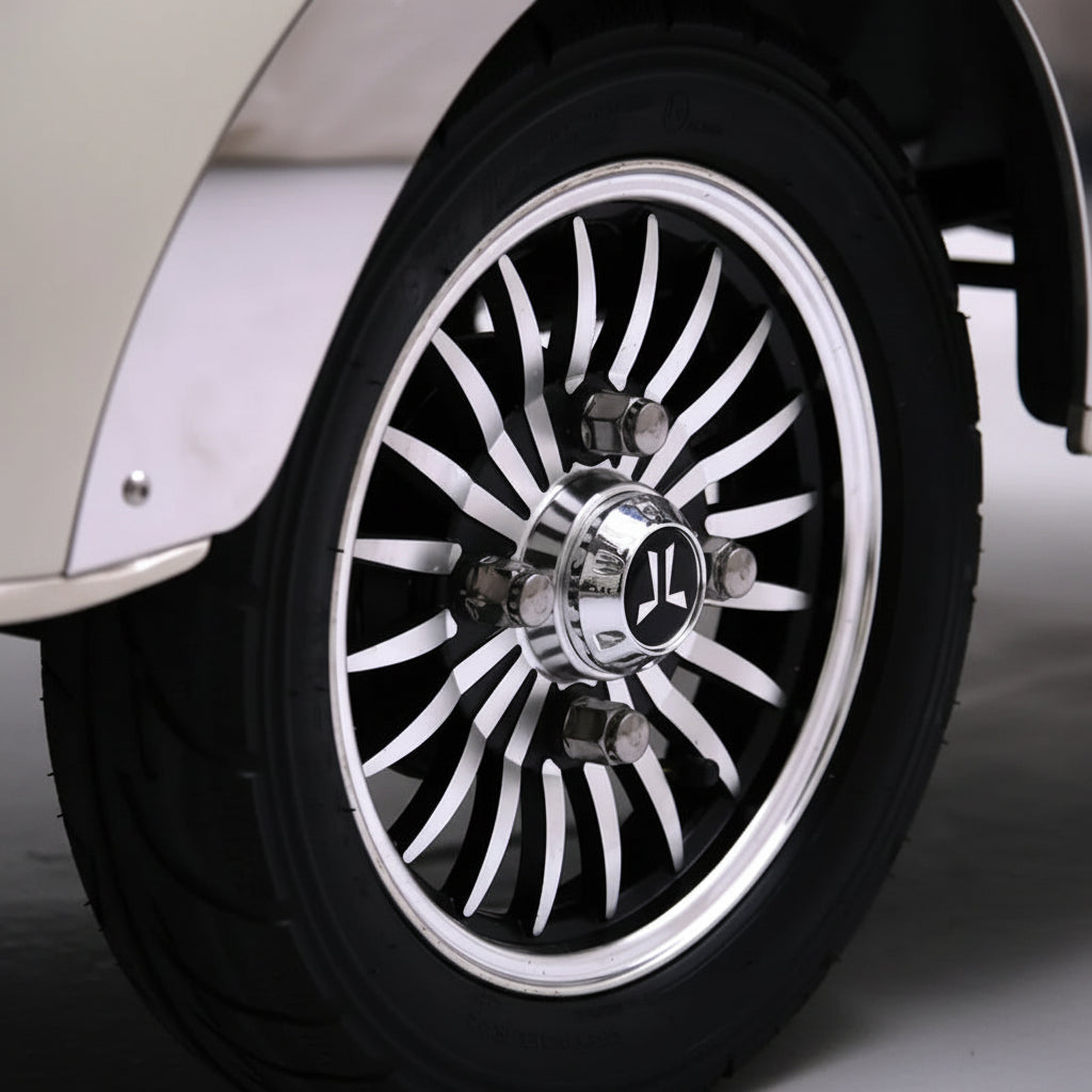 A close-up of a custom multi-spoke chrome and black wheel with a polished centre cap 