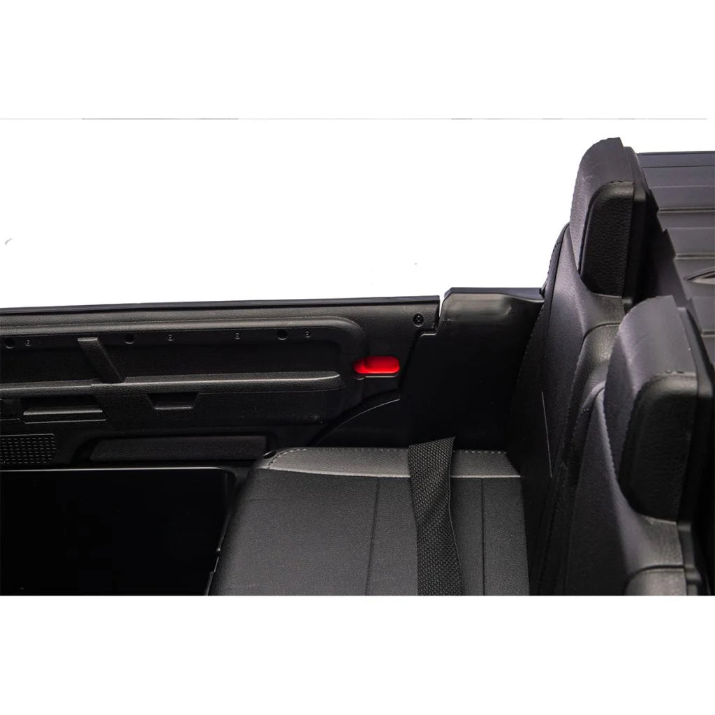 Car interior with a folded seat and open door of Land Rover Defender Licensed Ride On Car