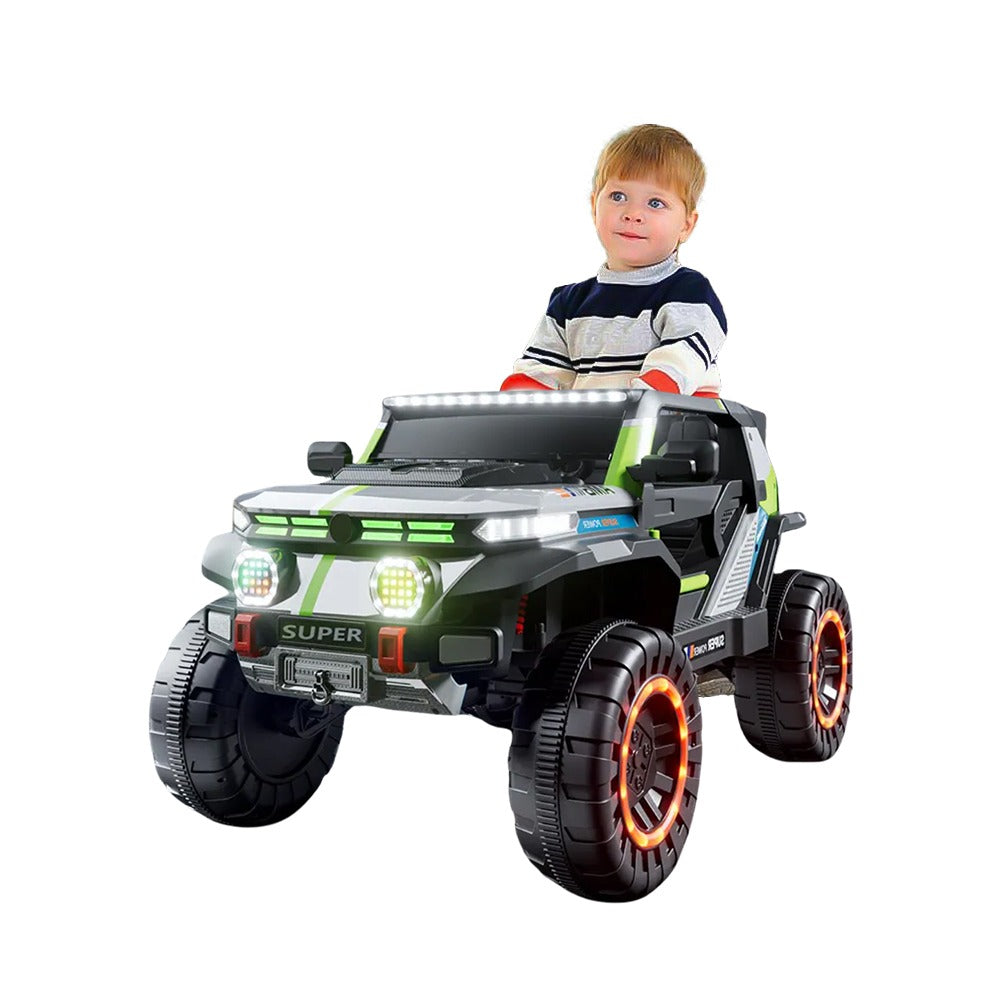 Child sitting in a Green Kids truck with glowing wheels