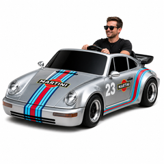 Man sitting in a sports car with Martini racing stripes 