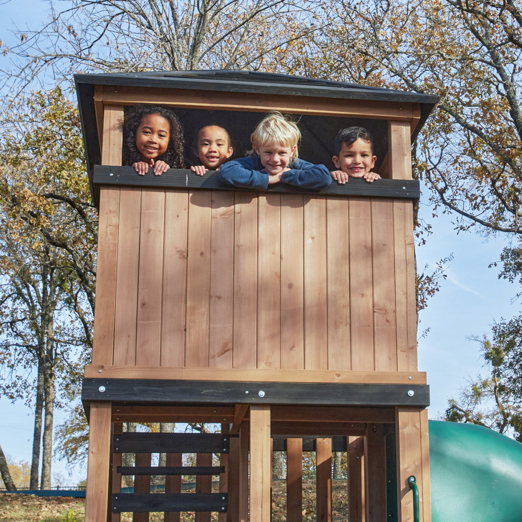 KidKraft Panorama Tower Children peeking out from a n open window 
wooden playhouse with trees in the background