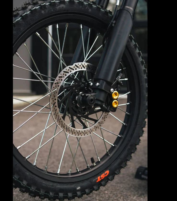 Close-up of a black off-road Talaria Sting MX5 electric dirt bike wheel 