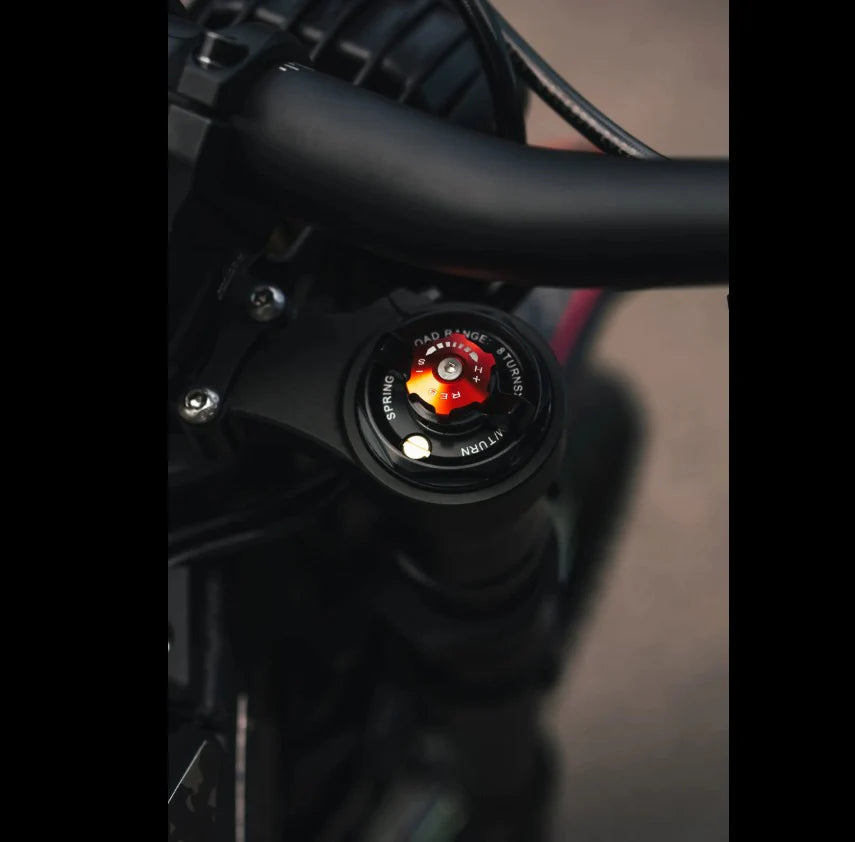 Close-up of a black Talaria Sting MX5 electric dirt bike handlebar.